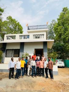 a group of people standing in front of a house at White House at Bhadane Saralgaon in Saralgaon