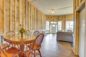 a dining room with a table and chairs and a couch at Downtown Lineville Vacation Rental about 10 Mi to Lake in Lineville