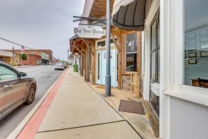 a street with a car parked next to a building at Downtown Lineville Vacation Rental about 10 Mi to Lake in Lineville