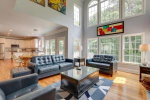 a living room with couches and a table at Spacious Home about 7 Mi to Stone Mountain Park! in Stone Mountain