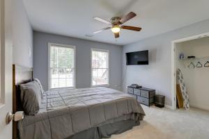 a bedroom with a bed and a ceiling fan at Spacious Home about 7 Mi to Stone Mountain Park! in Stone Mountain
