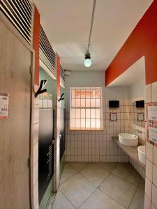baño grande con 2 lavabos y ventana en Bendito Hostels, en Bogotá