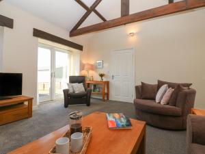 a living room with a couch and a tv at The Dairy in Bishop Auckland