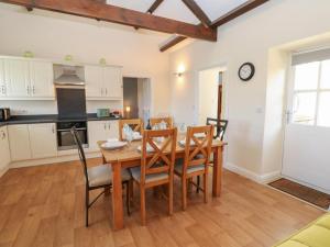 a kitchen and dining room with a wooden table and chairs at The Dairy in Bishop Auckland