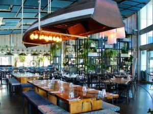 a restaurant with tables and chairs and a large chandelier at Sparkling New Apartment - Wollongong in Wollongong