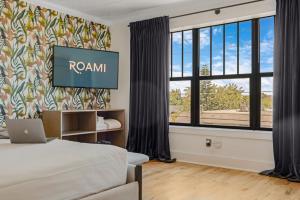 a hotel room with a bed and a window at Roami at Tower Hotel - Calle Ocho in Miami