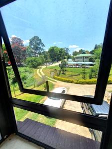 a window with a view of a park from a house at BEST APARTMENTS in Mbabane