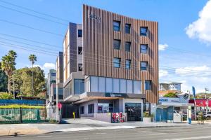 a building on the corner of a street at Scenic Wollongong Gem - City Location with Rooftop in Wollongong