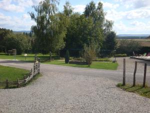 a gravel road with a fence in a park at La Roulotte au Paradis in Arc-et-Senans +13 photos