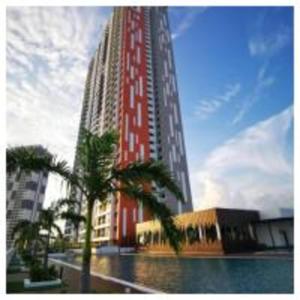 a tall red building with palm trees in front of it at Dreamstay36 3R2B 8pax Meritus perai in Perai
