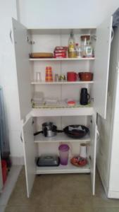 a kitchen with white shelving in a room at Casinha Aconchegante in Guarulhos