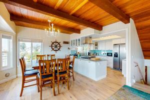 a kitchen with wooden ceilings and a table and chairs at All Decked Out in Cambria in Cambria