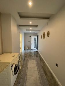 a laundry room with a washing machine and a hallway at Fuays Villa Premium in Trabzon