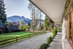 an estate with a view of a field and mountains at U Króla in Kościelisko