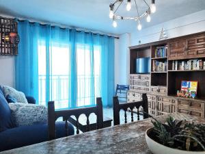 a living room with a table and chairs and a couch at Torre Hirta 1 in Peniscola