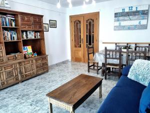 a living room with a blue couch and a table at Torre Hirta 1 in Peniscola