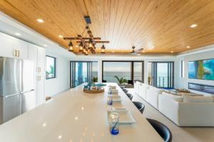 a large dining room with a long table and a couch at Tavernier Ocean Vista in Tavernier