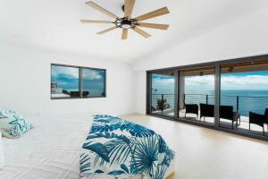 a bedroom with a bed with a ceiling fan at Tavernier Ocean Vista in Tavernier