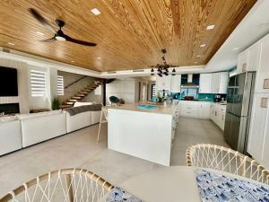 a kitchen with white cabinets and a wooden ceiling at Tavernier Ocean Vista in Tavernier +54 photos