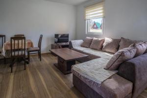 a living room with a couch and a table at Dubljevic in Žabljak