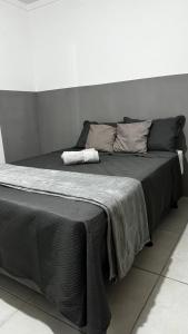 a large bed with a black blanket on it at Standard Garden 02 in Caruaru +44 photos