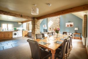 a dining room with a table and chairs and a kitchen at The Old Cart House in Westerdale