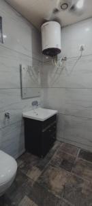uma casa de banho com um WC, um lavatório e um espelho. em Hotel Vinny em Jalandhar