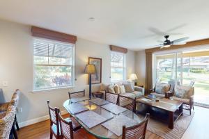 a living room with a table and chairs and a couch at Halii Kai 18E in Waikoloa