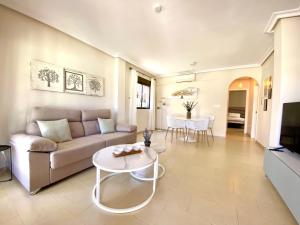 a living room with a couch and a table at Vrijstaande villa Torrevieja Casa Oeste in Torrevieja