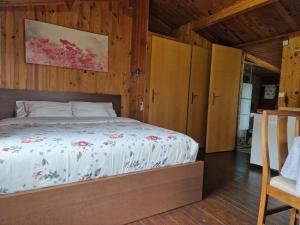 a bedroom with a bed in a room with wooden walls at La casita de invitados in Denia