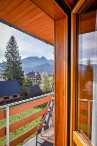 a room with a view of the mountains from a balcony at U Króla in Kościelisko