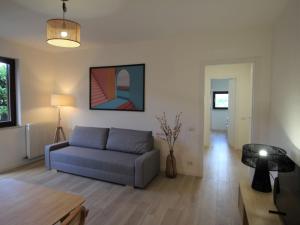 a living room with a couch and a table at Apartment Haridian by Interhome in Porto Valtravaglia