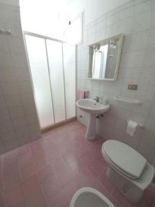 ein weißes Bad mit einem WC und einem Waschbecken in der Unterkunft Casa vacanze a 100mt dal mare in Torre Ovo