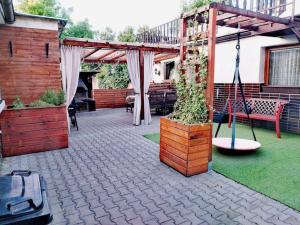 a patio with a bench and a swing at Love Home in Horní Heršpice