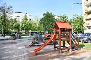 a playground with a slide in a park at Apartman Maja in Banja Luka