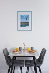 einen weißen Tisch mit Stühlen und Essen drauf in der Unterkunft Studio Harbour Nights 7B by Interhome in Lossiemouth