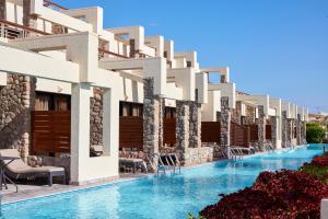 een hotel met een zwembad voor een gebouw bij Coral Sea Imperial "Coral Sea Sensatori" in Sharm El Sheikh