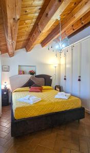 a bedroom with a large bed with yellow sheets at Il Nichessino in Ancona