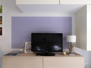 TV de pantalla plana en la parte superior de un armario de madera en Apartment Borghouse by Interhome, en Borghetto Santo Spirito