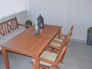 a wooden table with two chairs and a table with a plant at Apartment Luxury Apartment Mondo-3 by Interhome in Vir