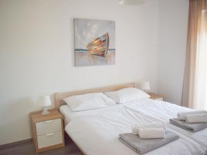 a bedroom with a bed with two towels on it at Apartment Luxury Apartment Mondo-3 by Interhome in Vir