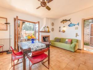 uma sala de estar com uma mesa e um sofá em Holiday Home Le Sughere by Interhome em Porto Ercole