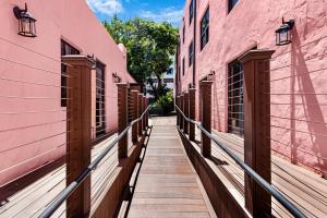 a walkway between two pink buildings at Roami at Tower Hotel in Miami