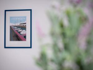 a picture hanging on a wall with a picture of boats at Studio Harbour Nights 7A by Interhome in Lossiemouth