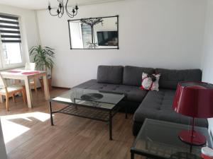 a living room with a couch and a table at Mikołajki Apartamenty Rynek in Mikołajki