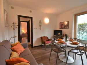 a living room with a couch and a table at Apartment Olmo Garden Apartment by Interhome in Morbegno