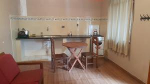 a kitchen with a counter and a table and chairs at Cruz Popayan Sucre in Sucre