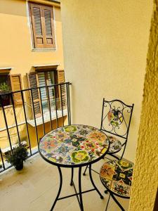 a table and two chairs sitting on a balcony at Corleone Home in Corleone