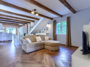 a living room with a couch and a kitchen at Villa Feniks by Interhome in Višnjan