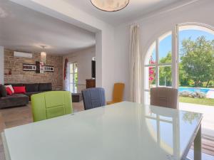 a kitchen and living room with a table and chairs at Villa Bella by Interhome in Marčana